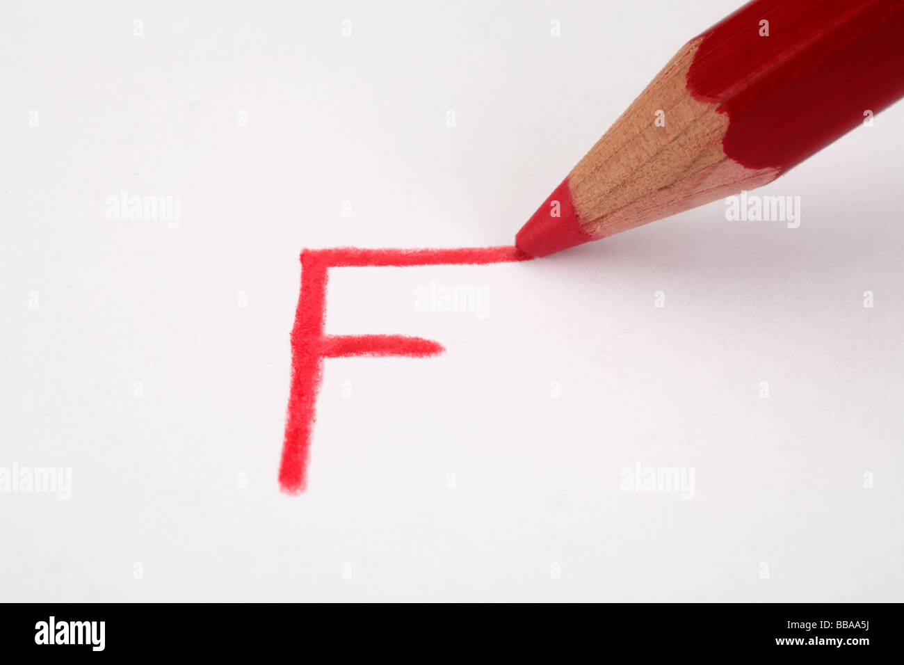 Red pencil marking an F on paper close up Stock Photo