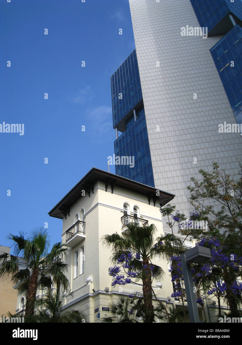 An old reconstructed edifice with glassed office building in Rothschild Boulevard, downtown Tel Aviv Israel Stock Photo