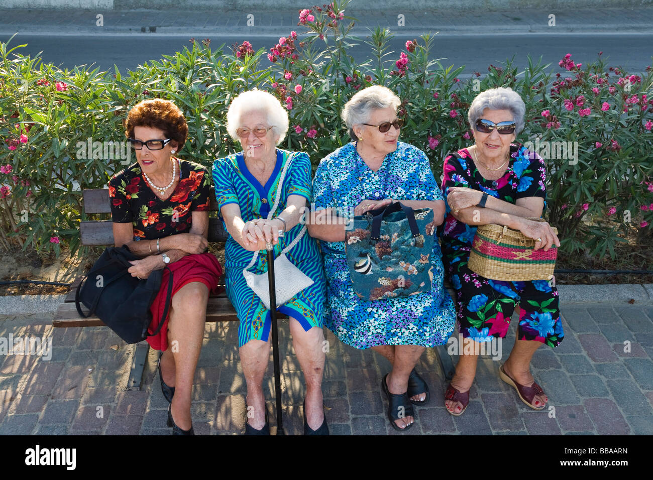 Senior women sitting on a bench, Elba, Tuscany, Italy, Europe Stock Photo