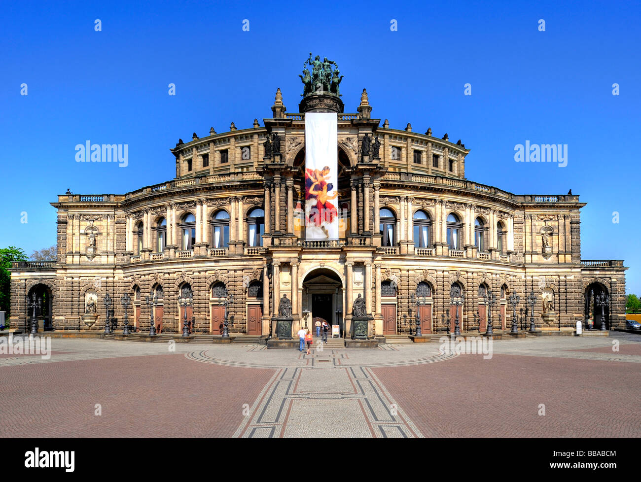 Semperoper Opera house with flags, Theaterplatz square, Dresden, Free State of Saxony, Germany, Europe Stock Photo