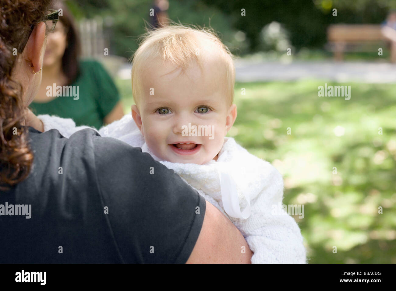 Mother carrying child over shoulder hires stock photography and images