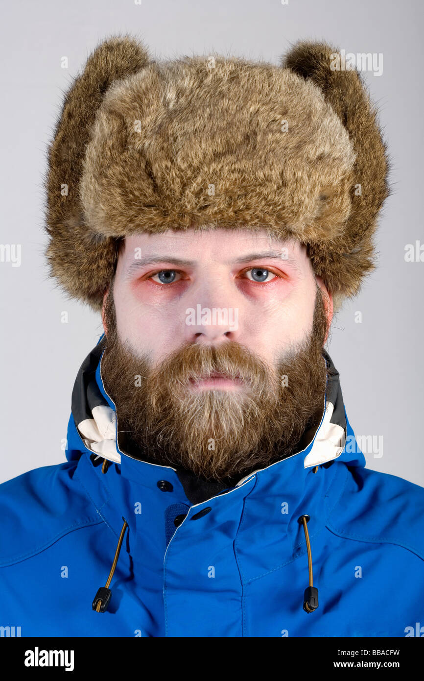 A man wearing warm clothes and has pale skin and red eyes Stock Photo