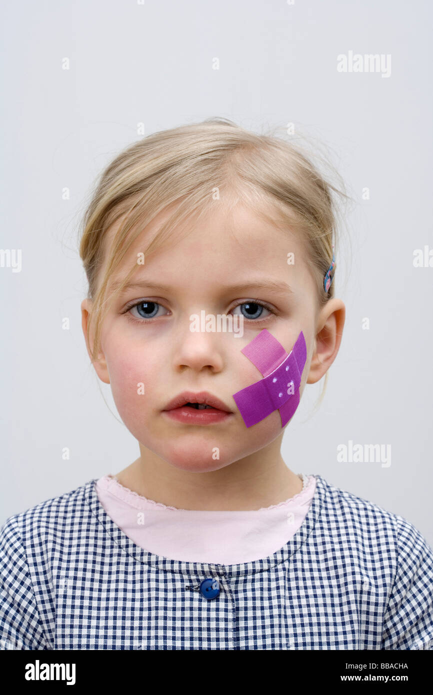 A young girl with a adhesive bandage on her cheek Stock Photo - Alamy