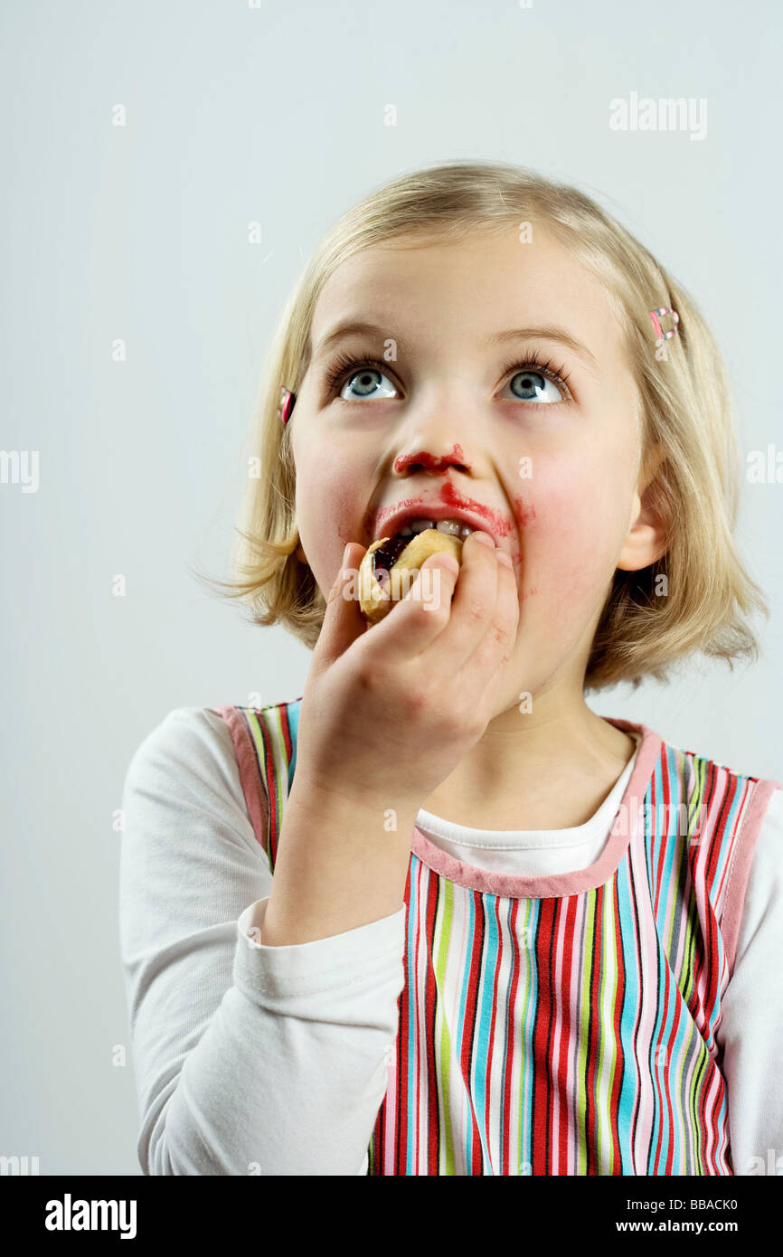 A young girl eating bread and jam Stock Photo Alamy