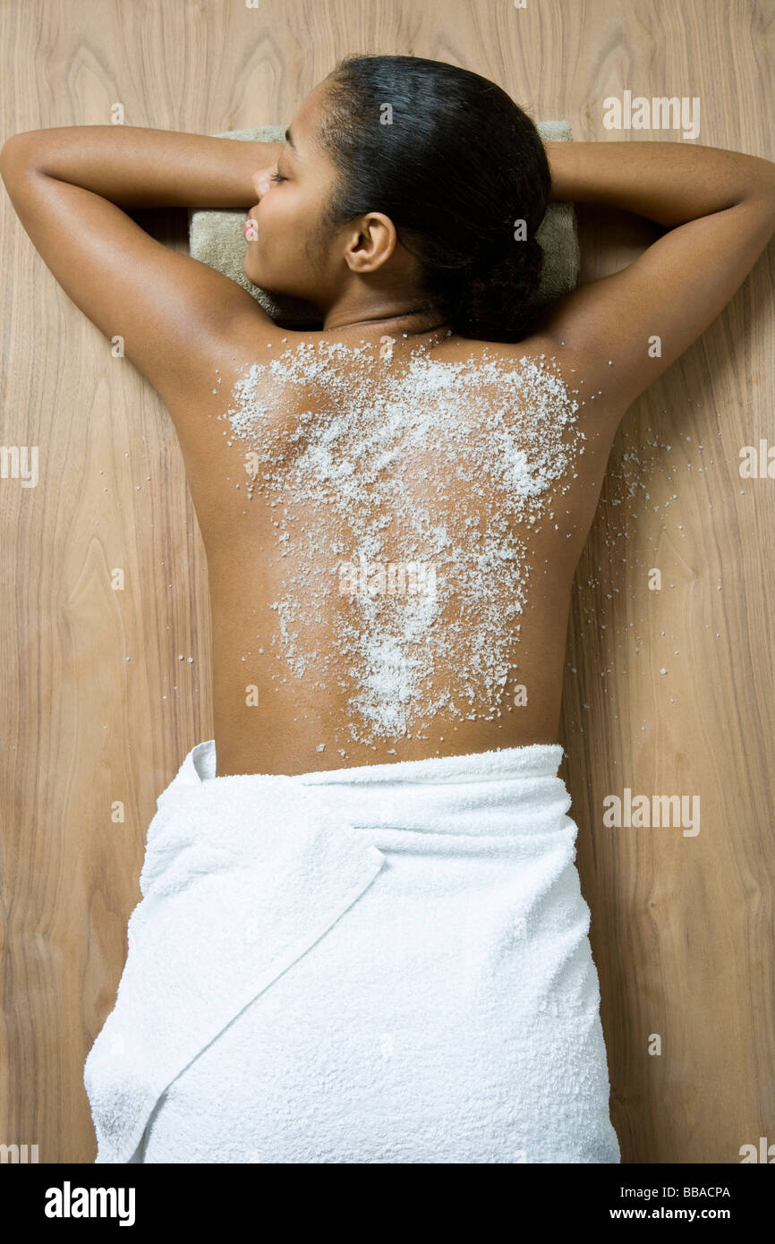 A young woman lying on her front and having a spa treatment Stock Photo