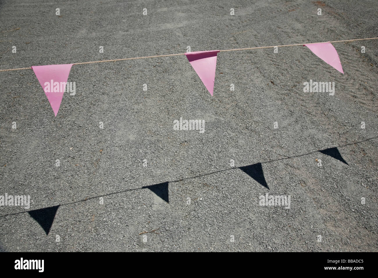 Pink bunting hanging above a road Stock Photo