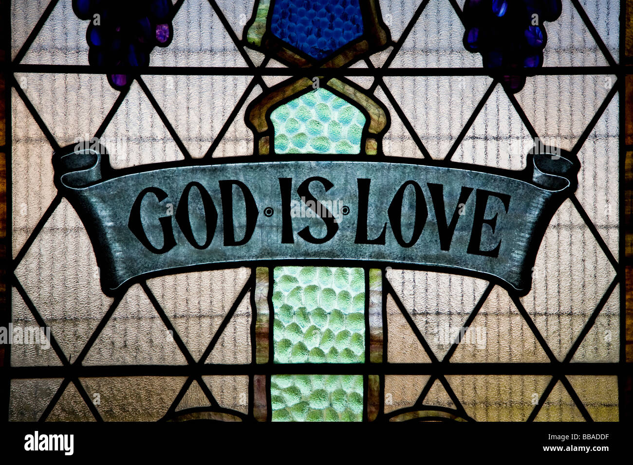 God Is Love written in a stained glass window Stock Photo