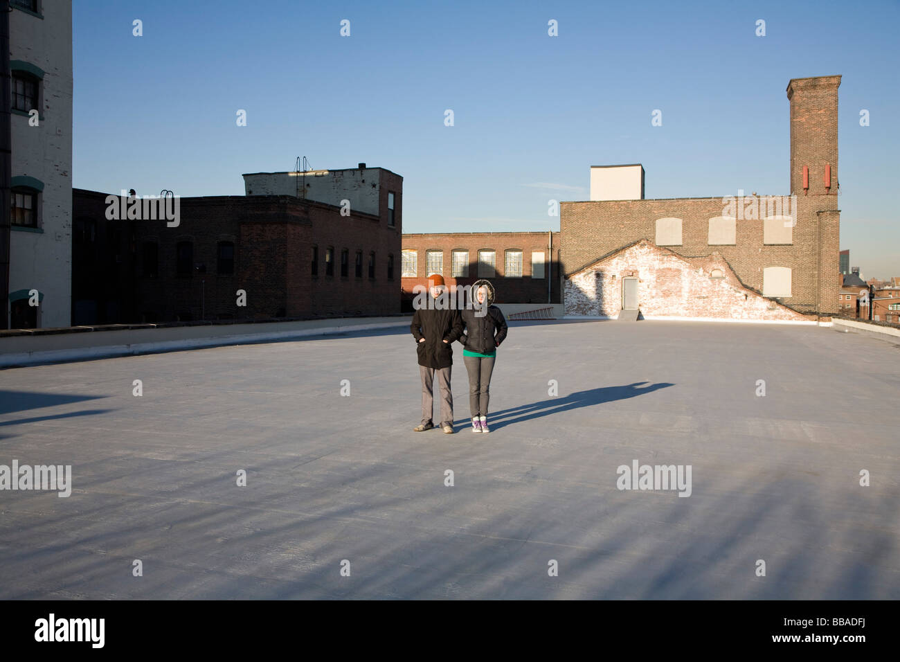 A woman and a man standing on a roof Stock Photo - Alamy