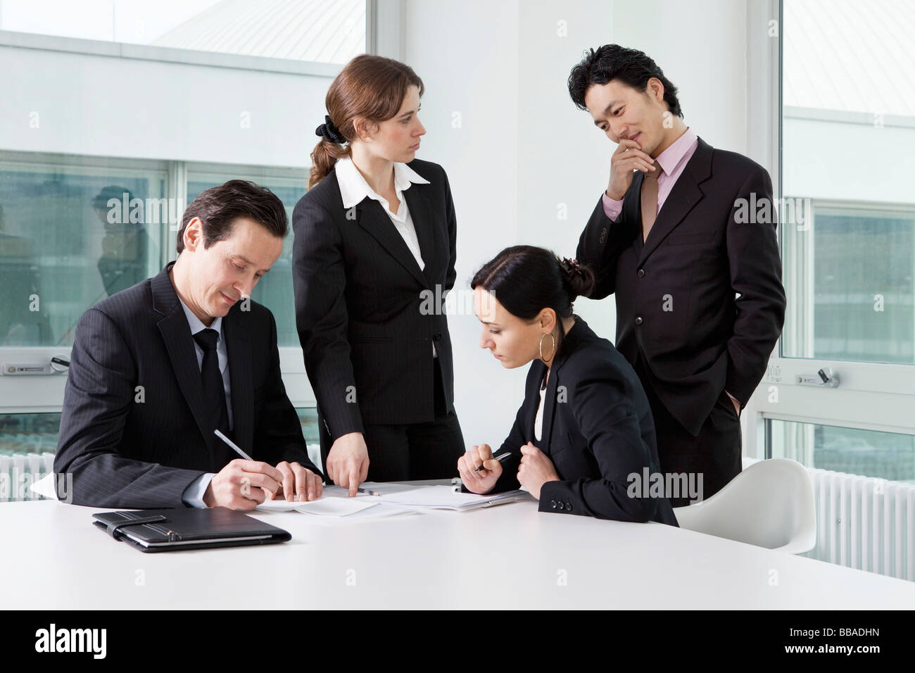 Four business people in a business meeting Stock Photo - Alamy