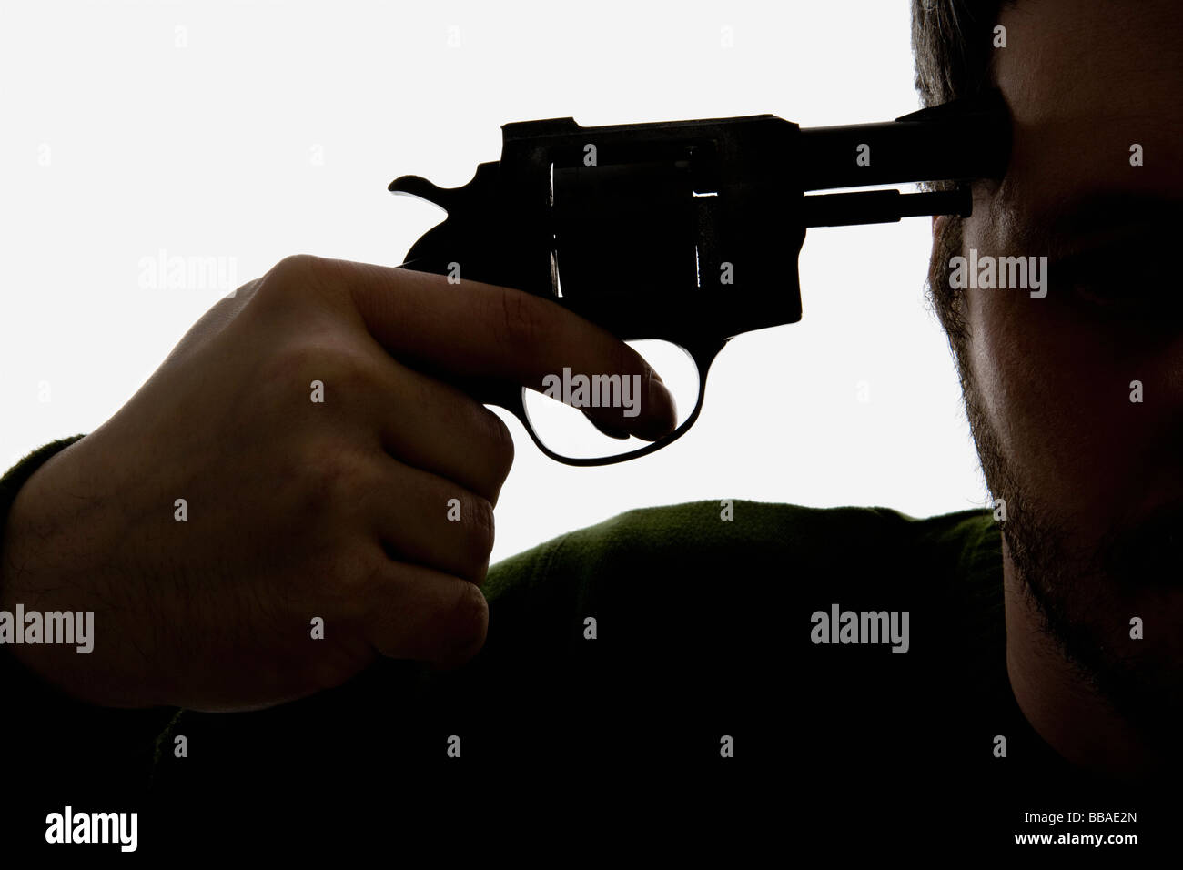 Detail of a man holding a gun to his head Stock Photo