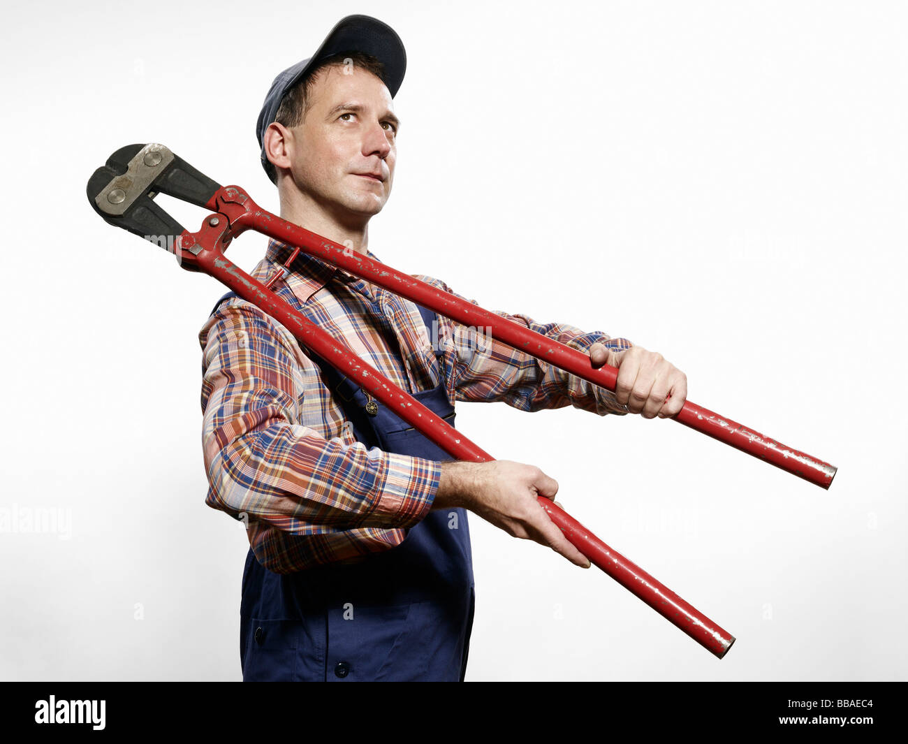 A man holding bolt cutters over his shoulder Stock Photo Alamy