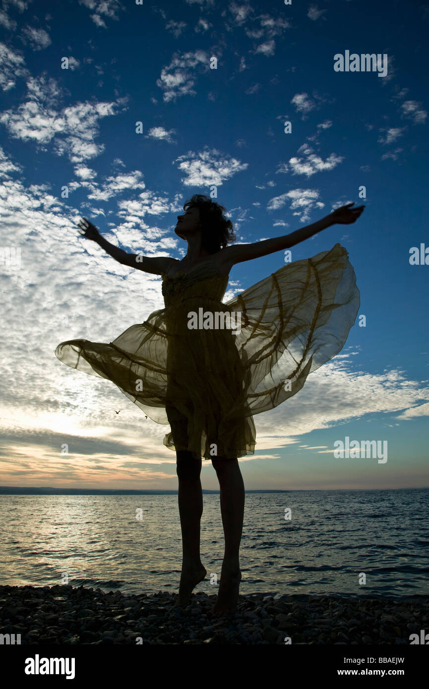 A woman with her arms raised and carefree Stock Photo - Alamy