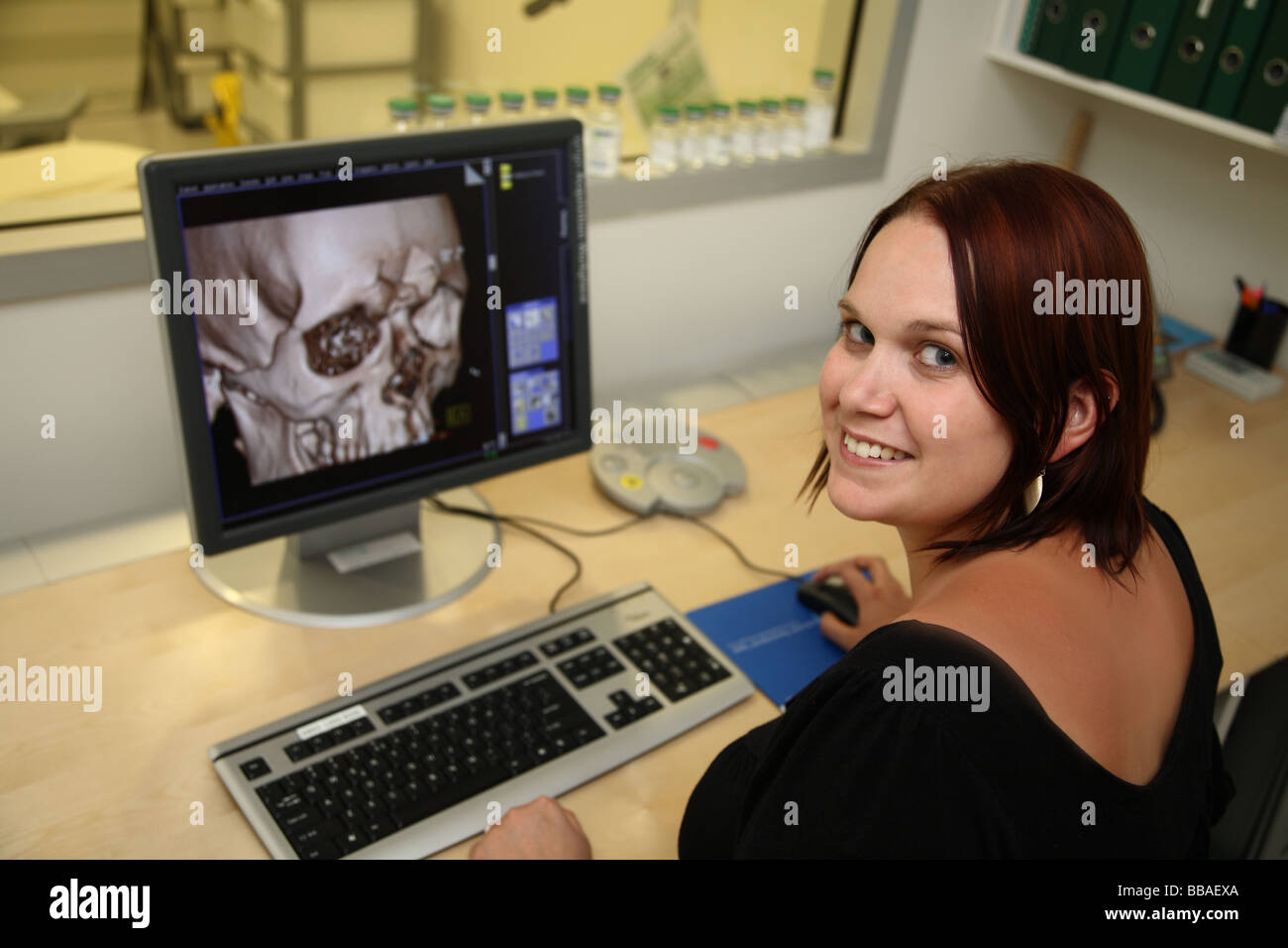Radiographer checking CT images of broken skull Stock Photo