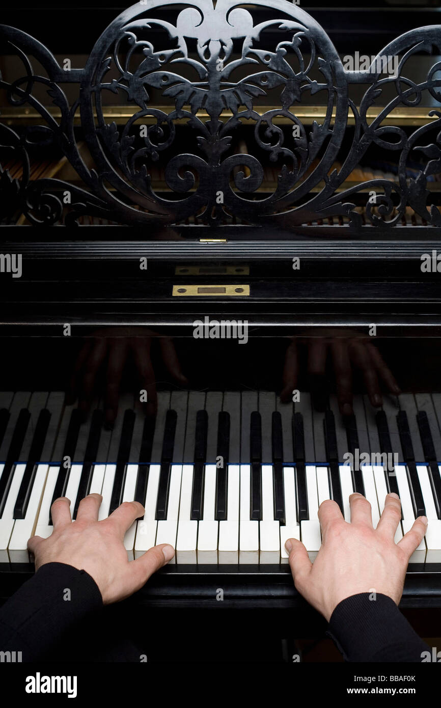 Human hands playing a piano Stock Photo