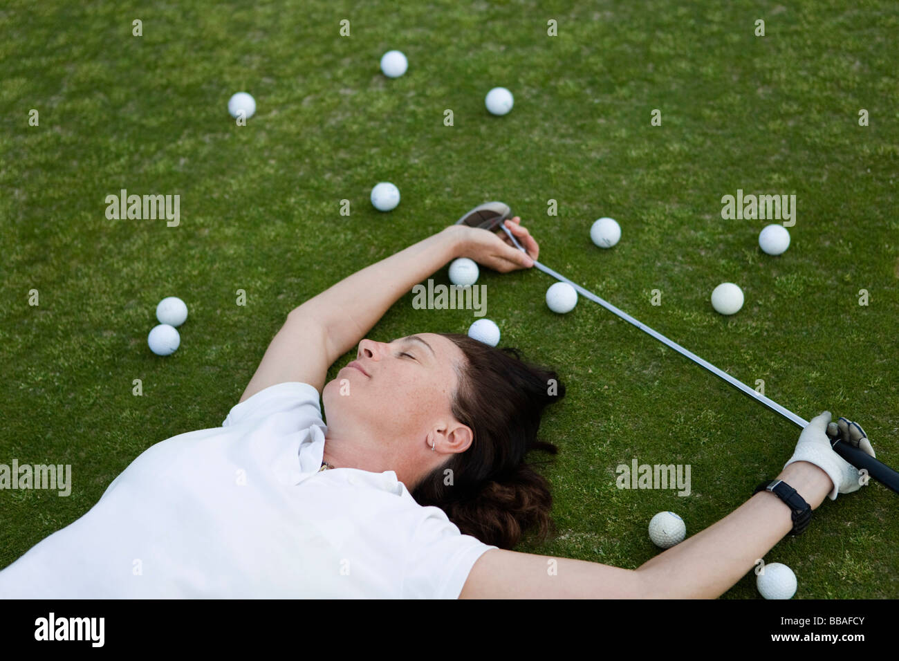 An exhausted golfer lying down on a golf course Stock Photo Alamy