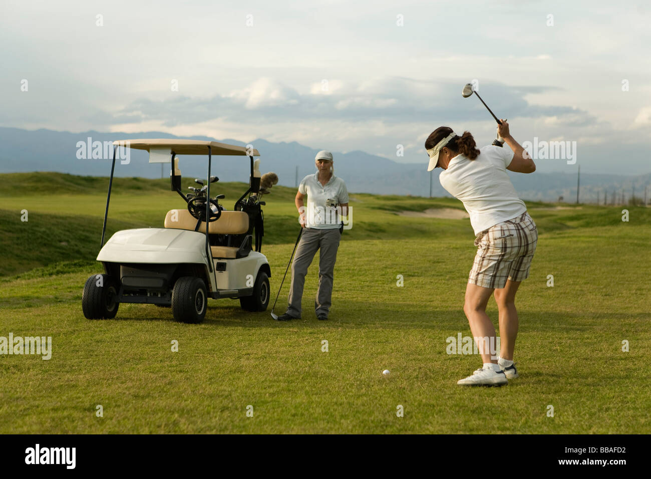 Two women playing golf together, Palm Springs, California, USA Stock Photo