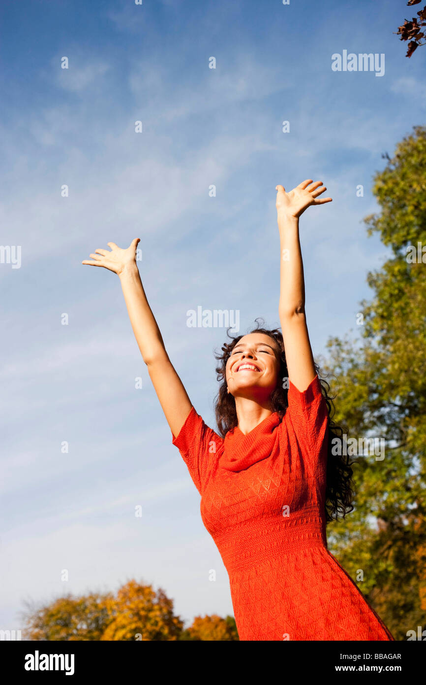 young woman under blue sky Stock Photo - Alamy