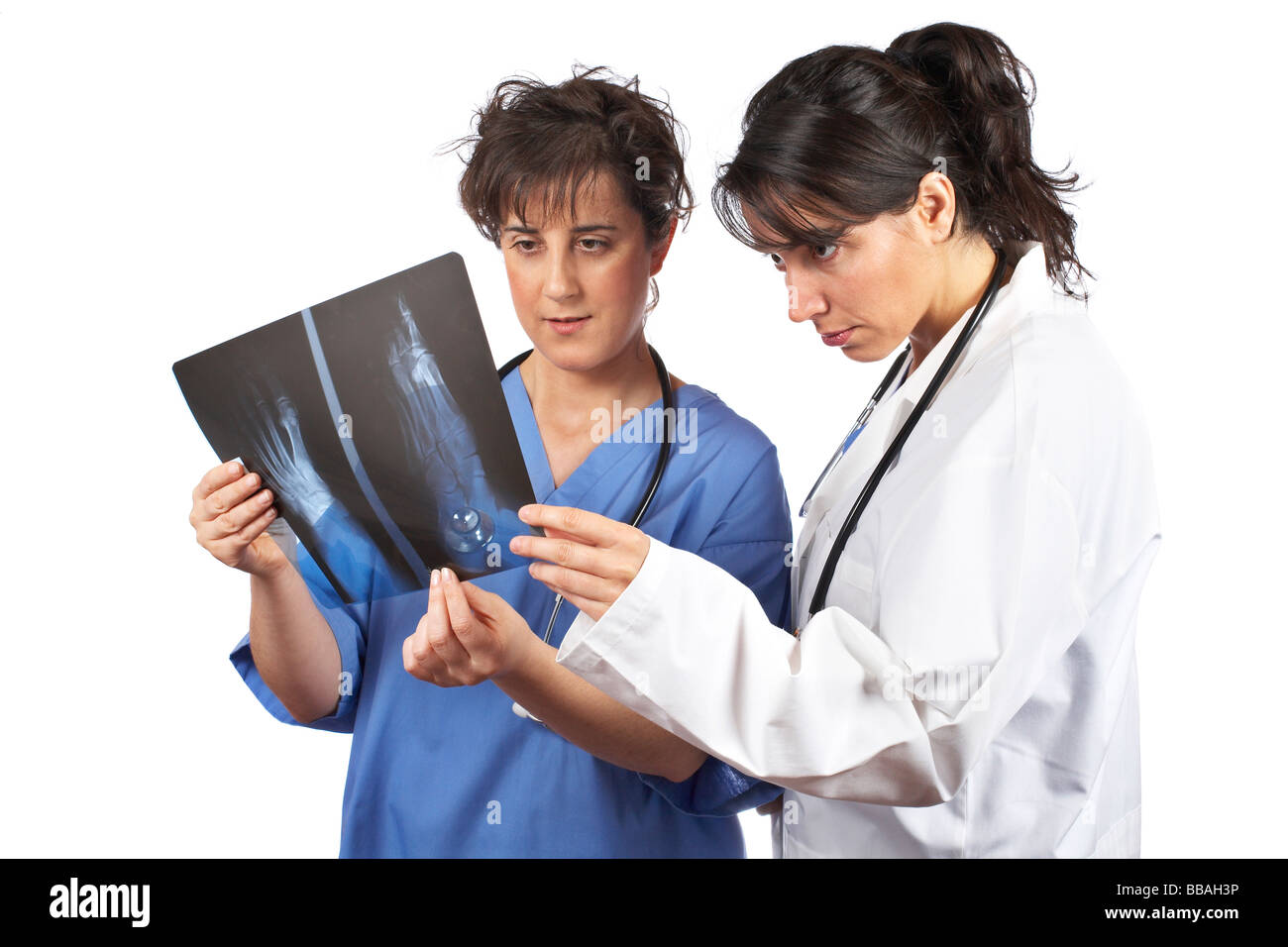 Two female doctors examining x ray isolated on white background Stock ...