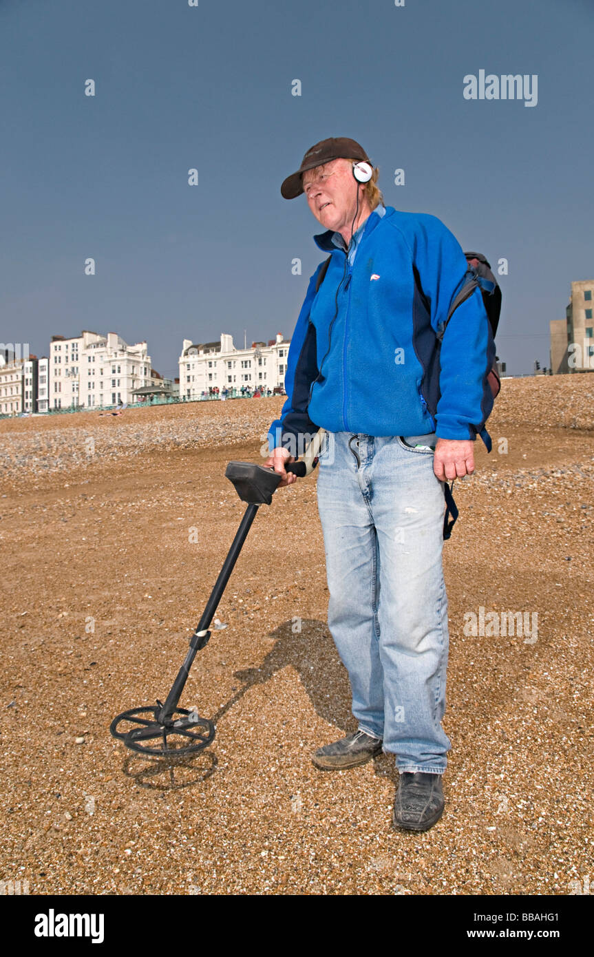 a metal detecting man on brighton beach trying to find money Stock Photo