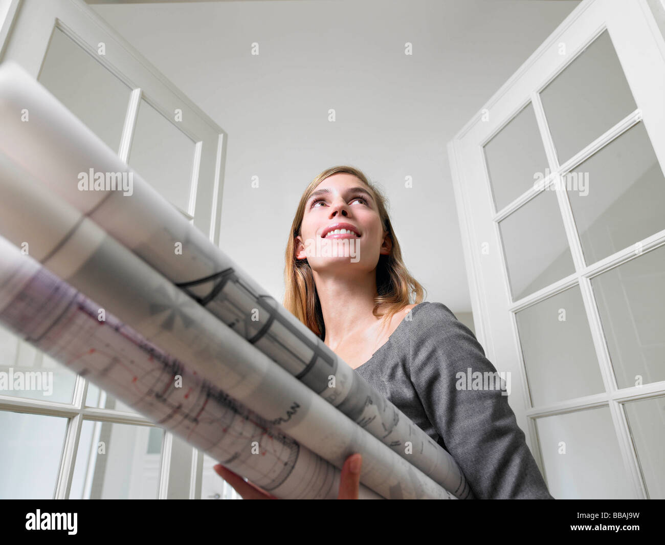 Woman holding blue prints Stock Photo
