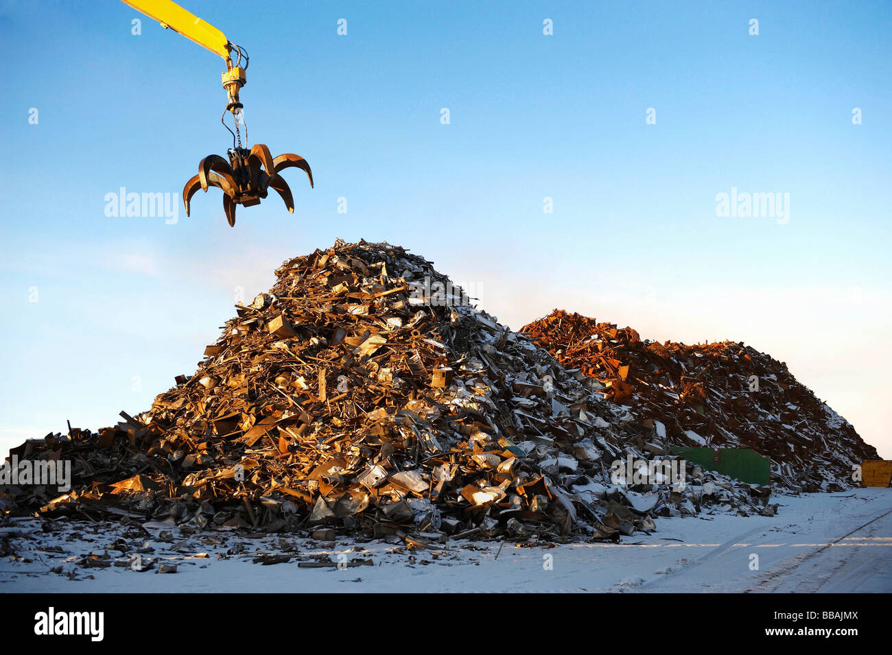 Pile of scrap metal with crane Stock Photo