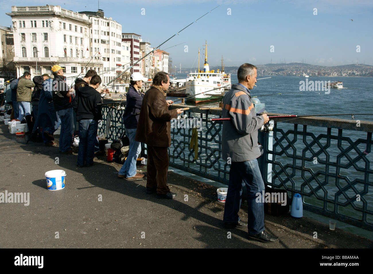 Fishermen line the sides of the Galata Bridge the Golden Horn Istanbul Turkey (c) Marc Jackson Photography Stock Photo
