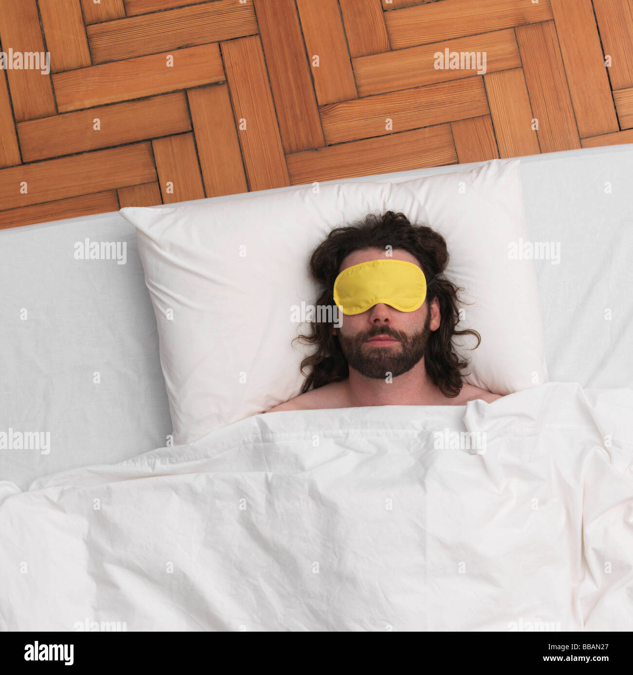 Man sleeping, wearing eyemask Stock Photo Alamy