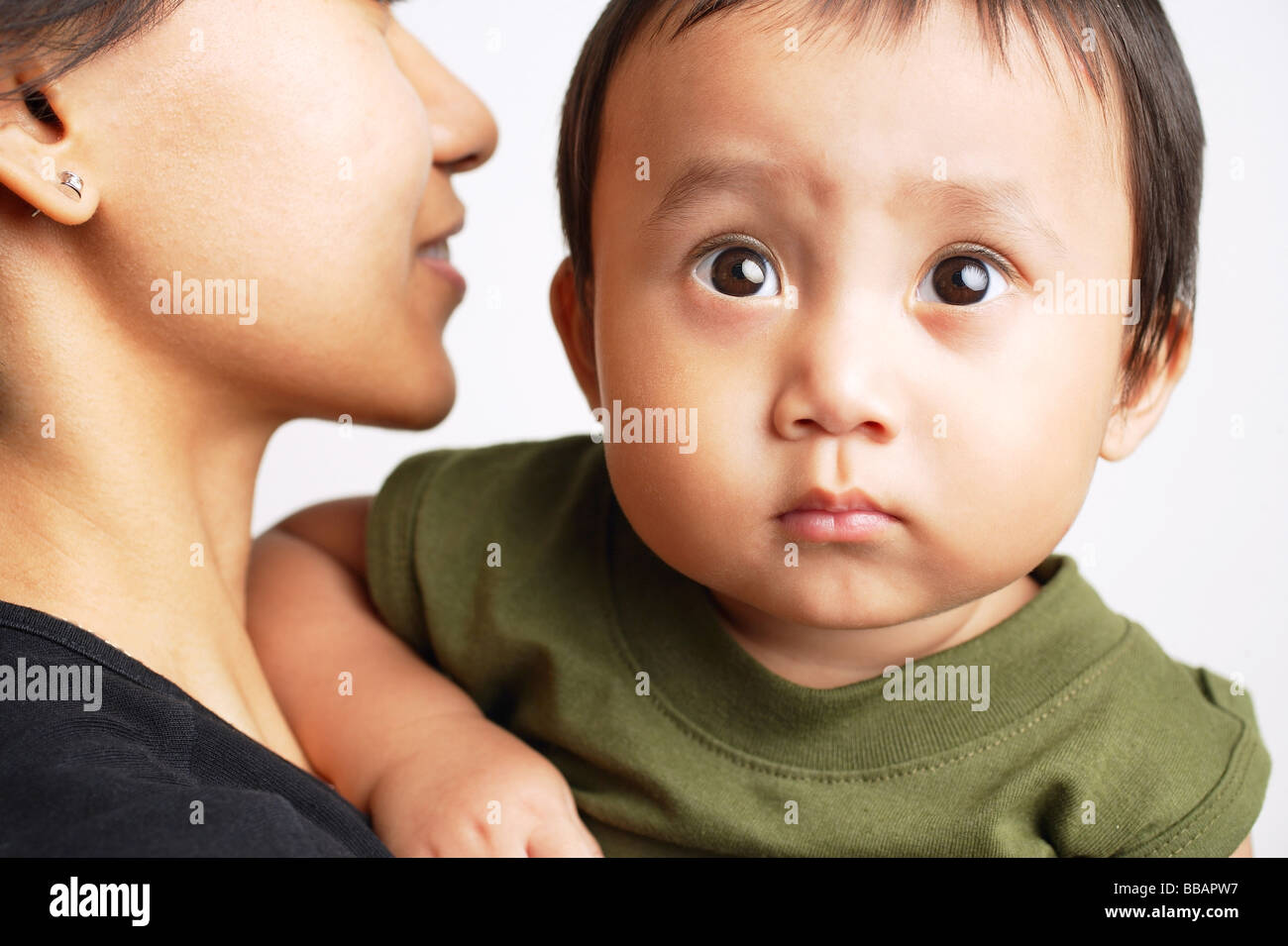 Mother carrying baby boy, boy looking forward Stock Photo Alamy