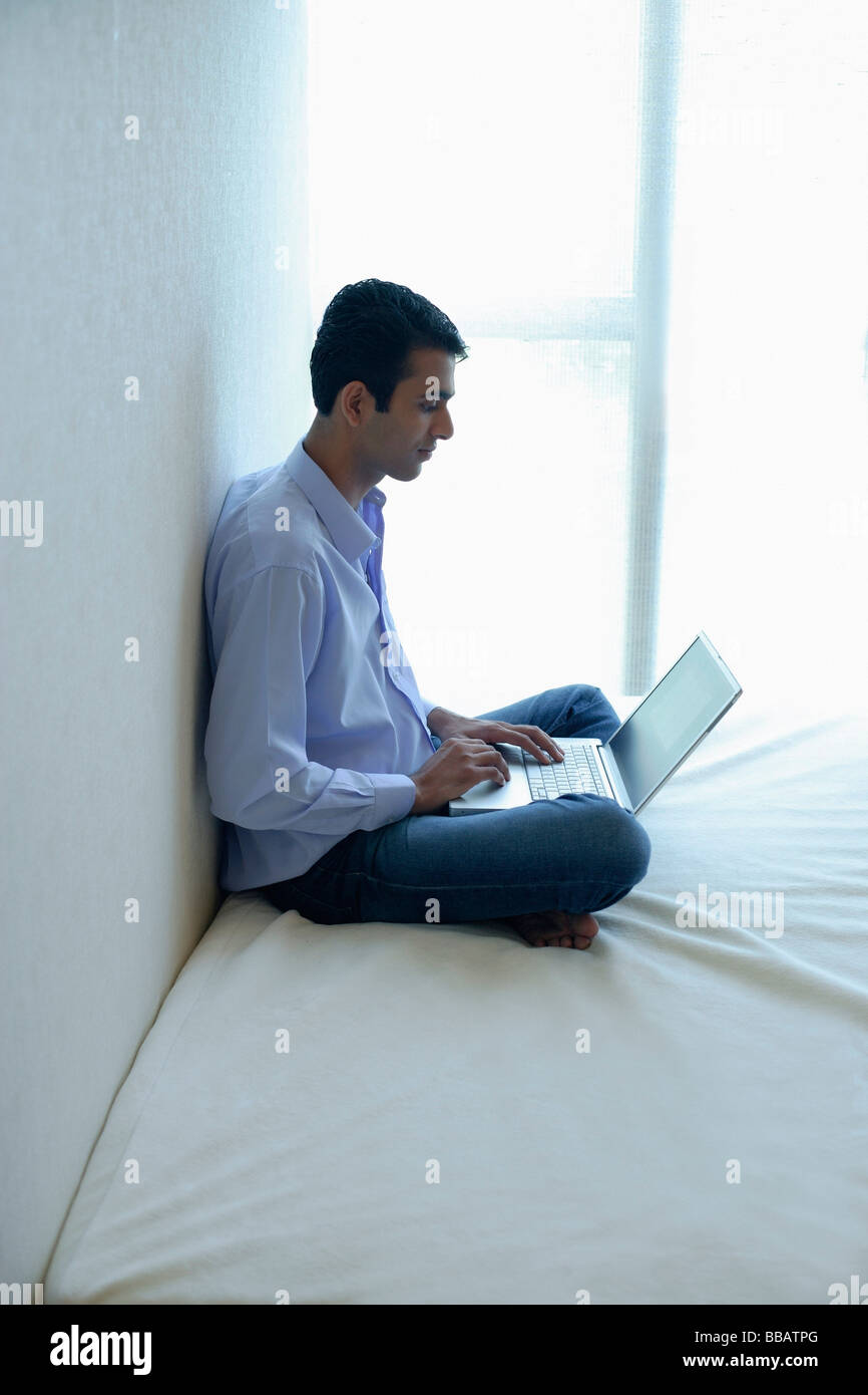 Indian man using laptop at home hi-res stock photography and images - Alamy