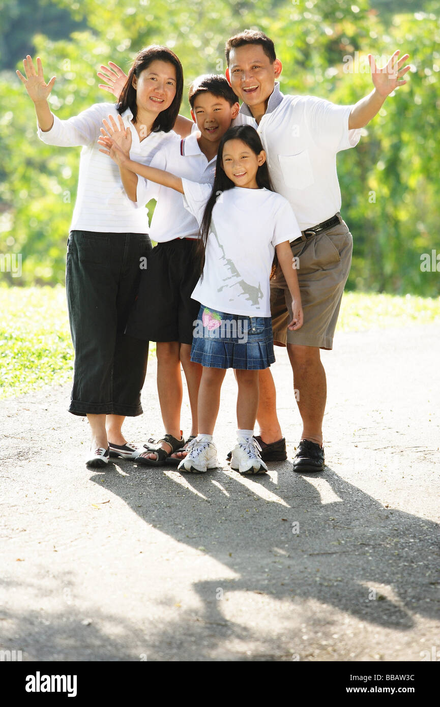 Family standing together, smiling, waving Stock Photo Alamy
