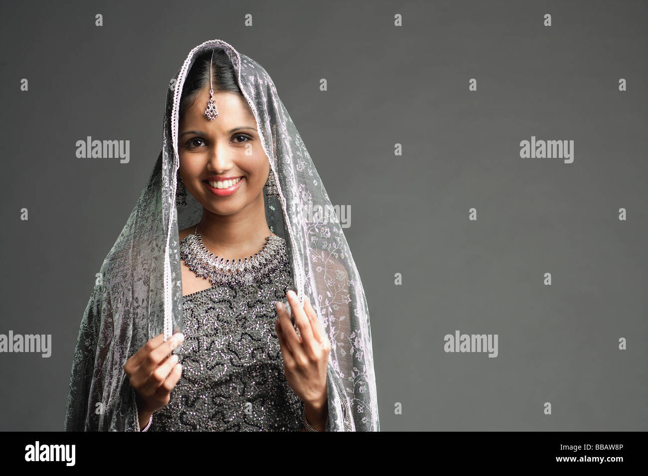 Woman in gray sari smiling at camera, portrait Stock Photo - Alamy