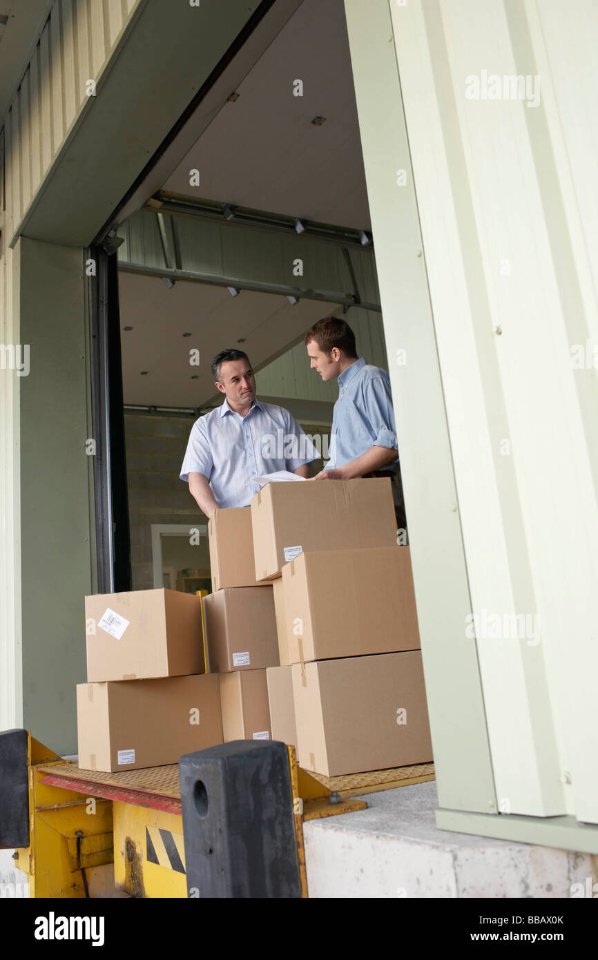 Two businessmen in warehouse Stock Photo