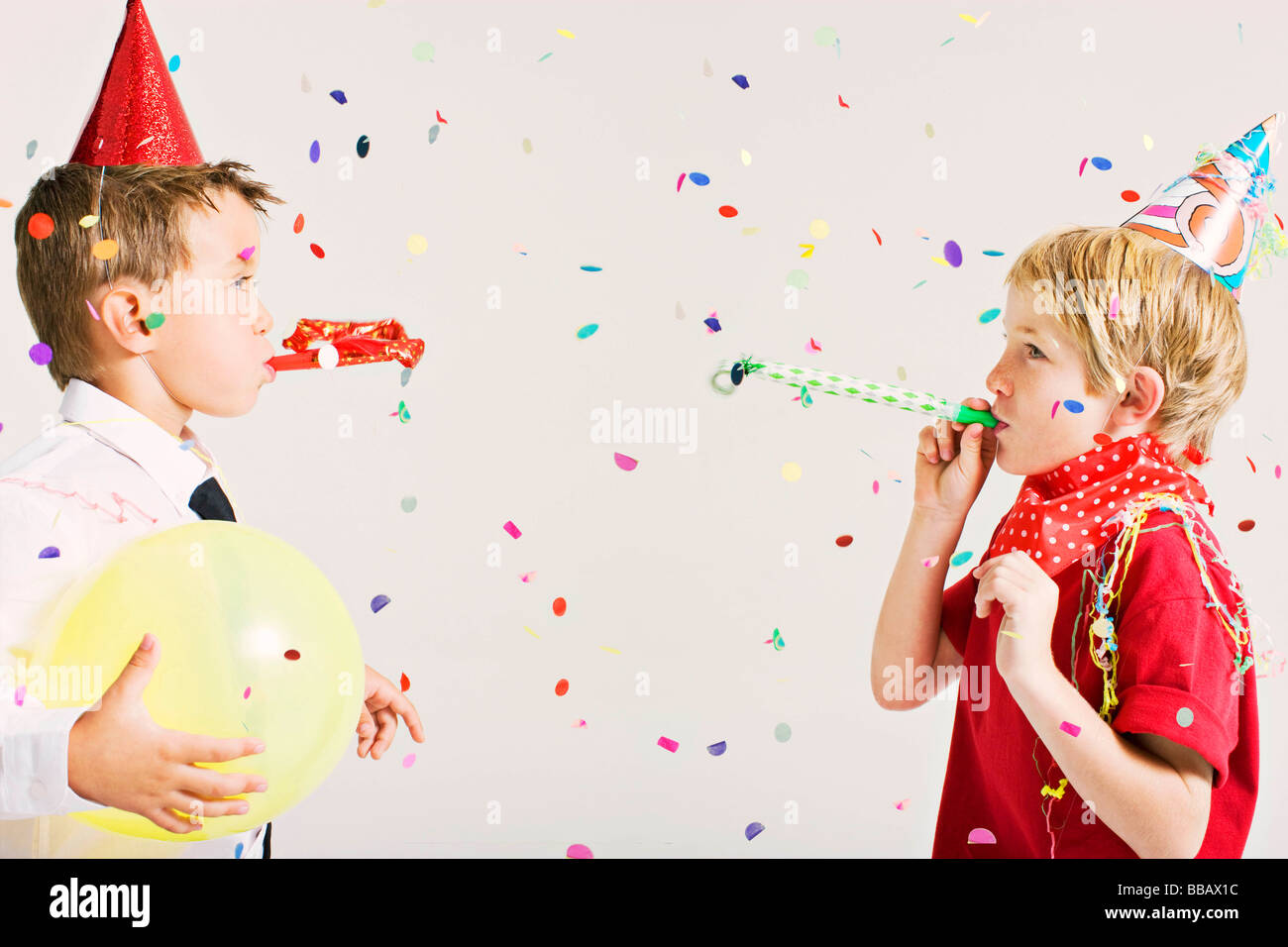 party boys blowing party blowers Stock Photo Alamy