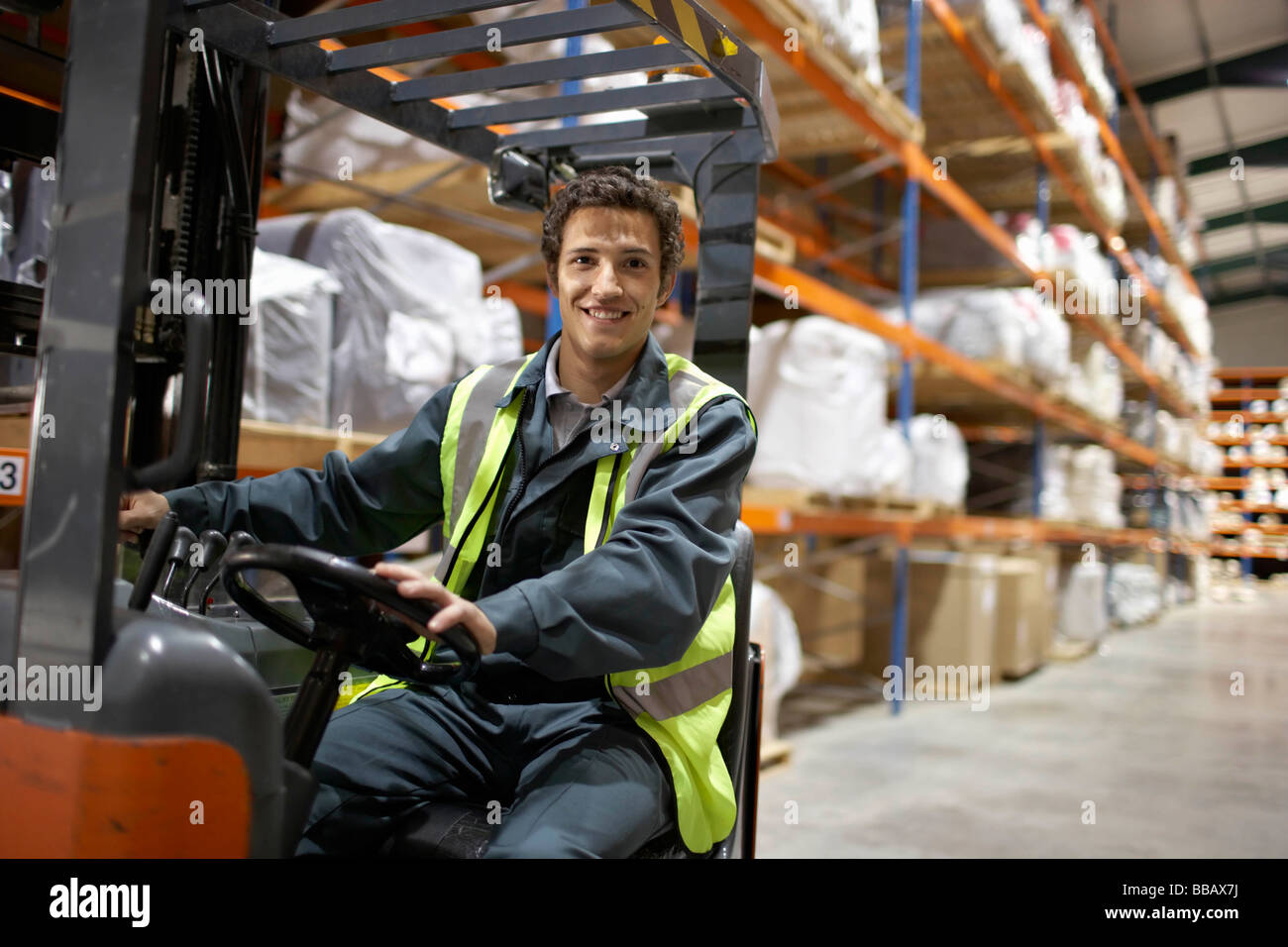 Worker on forklift, smiling to camera Stock Photo