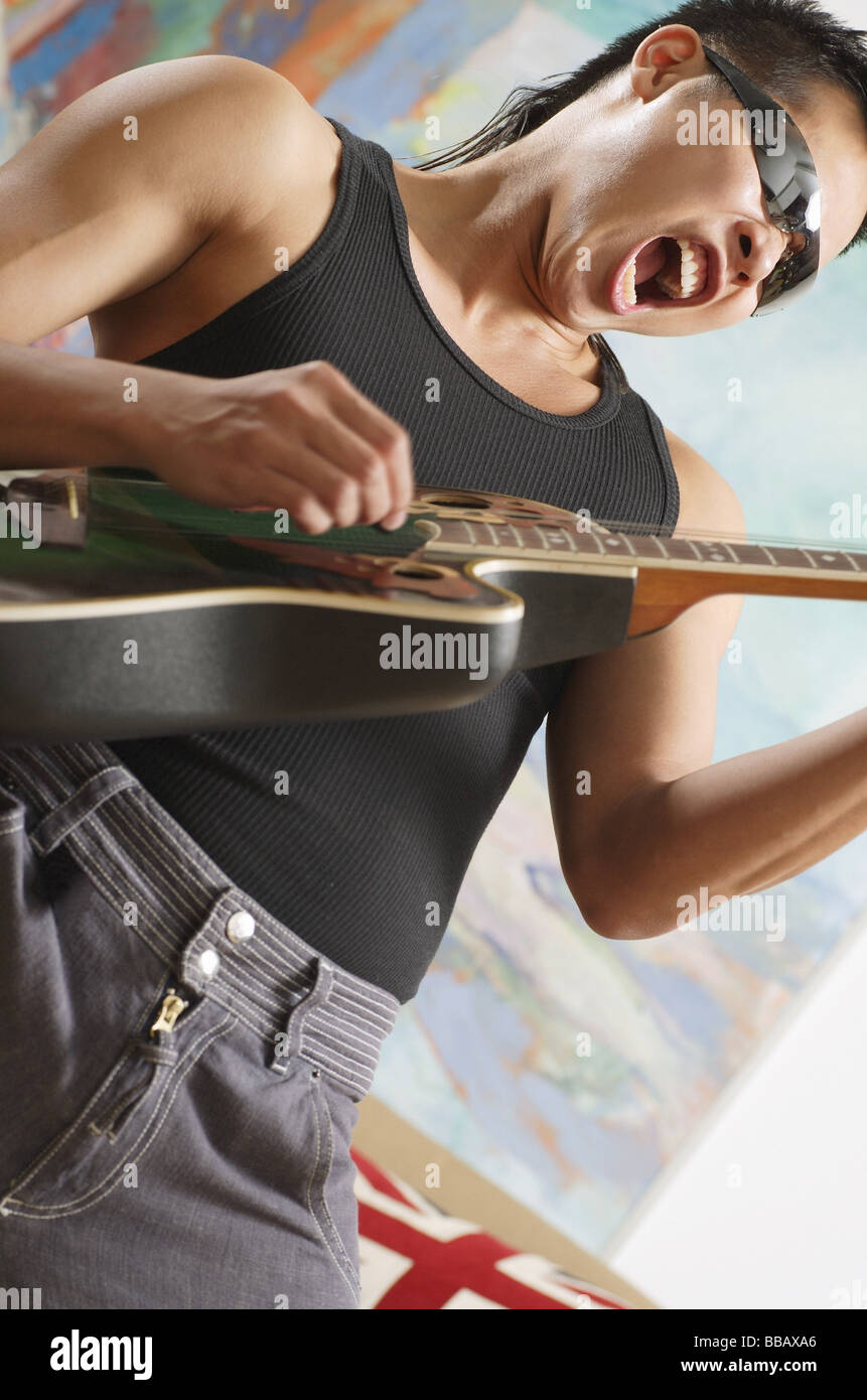 Man playing guitar, mouth open Stock Photo Alamy