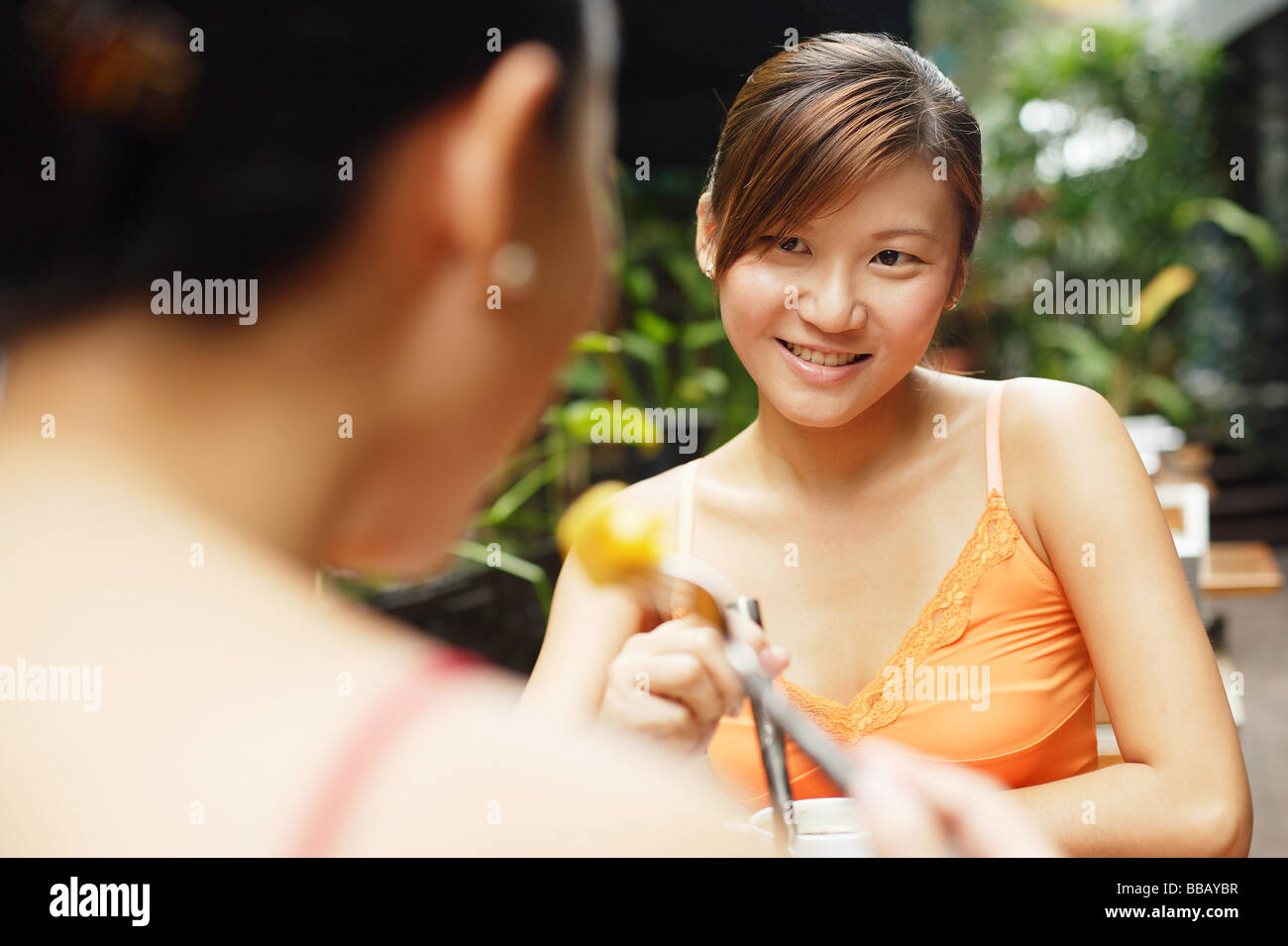 Girl eating out another