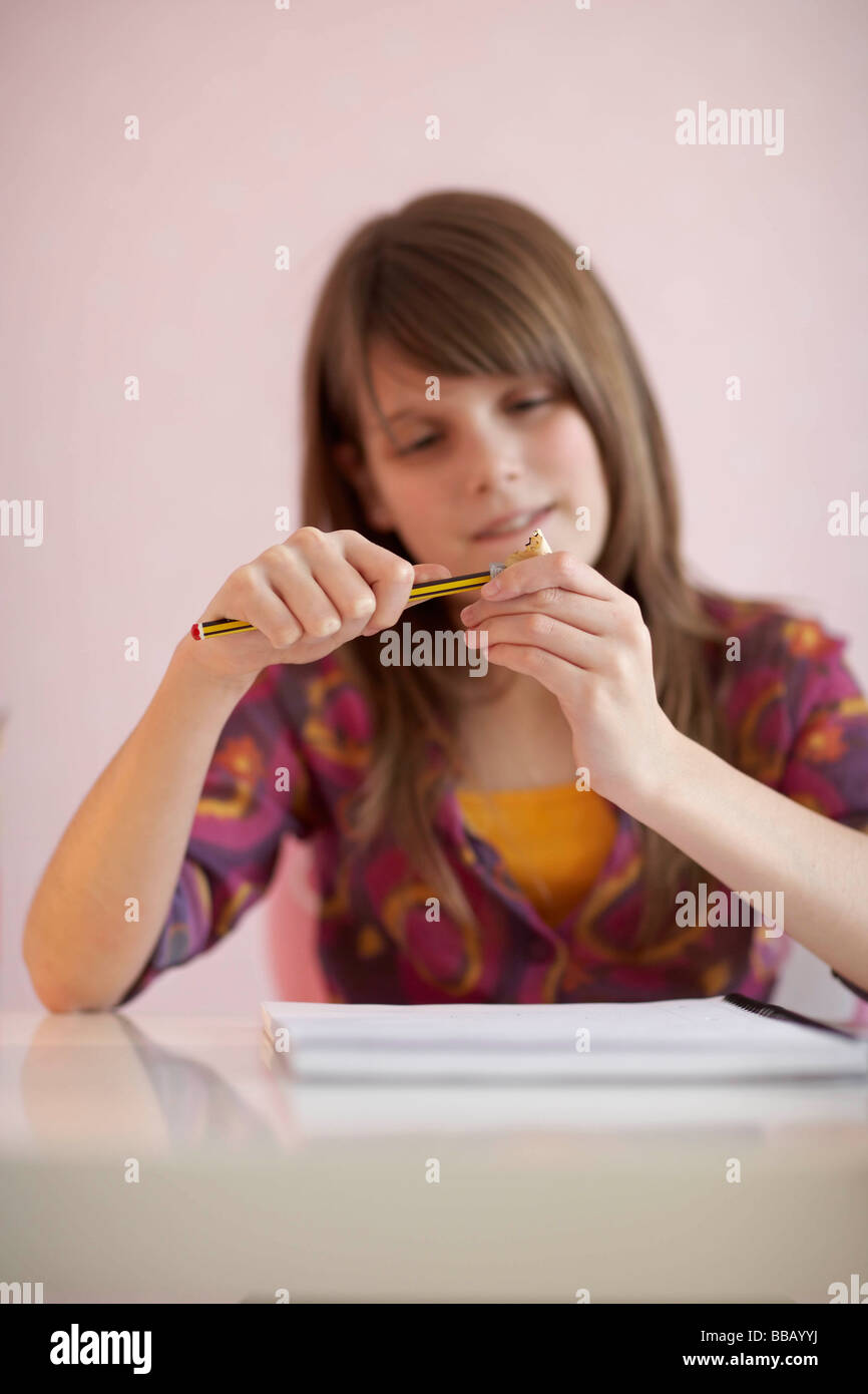 Teenage girl sharpening pencil Stock Photo Alamy