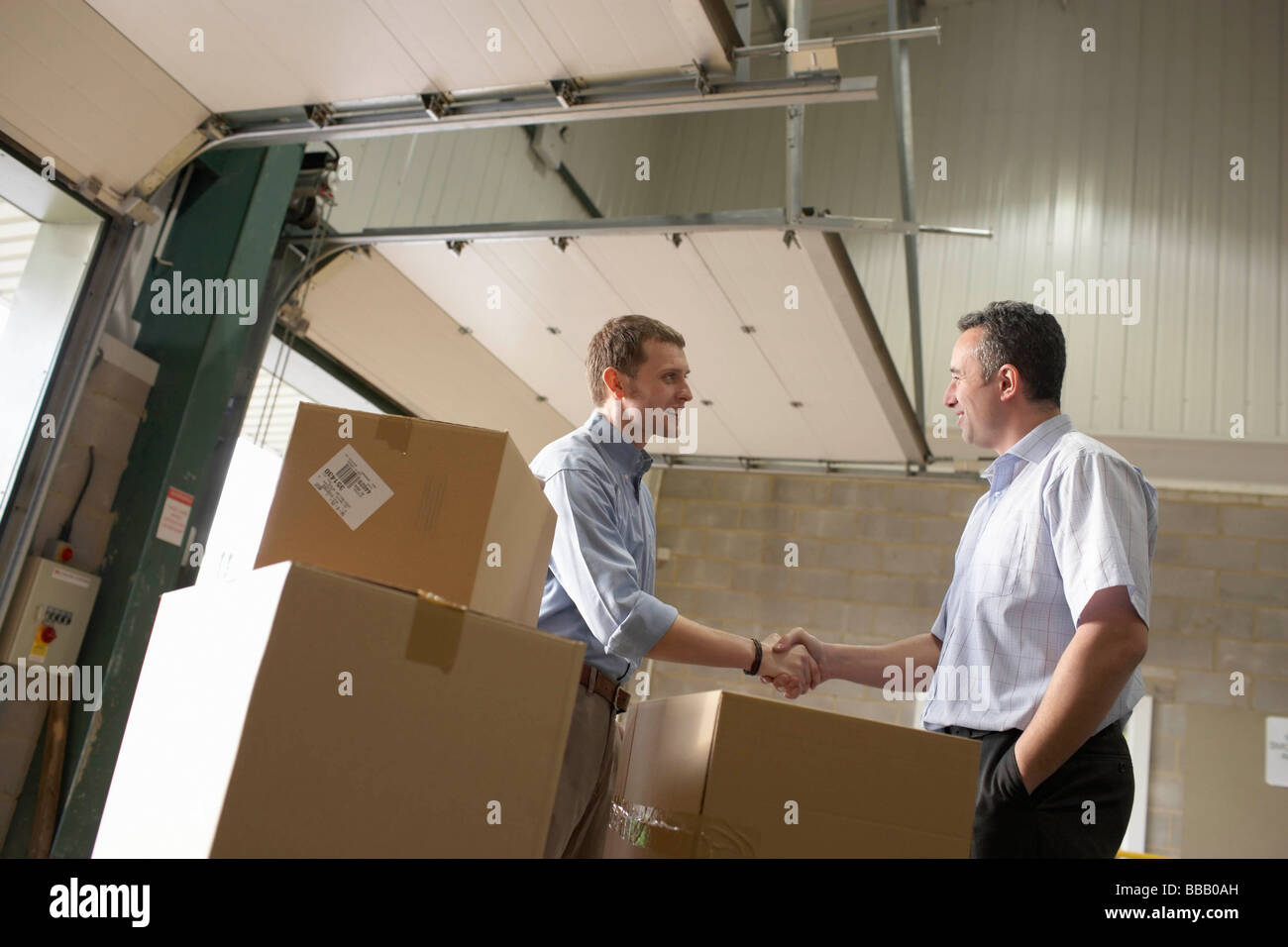 Two businessmen in warehouse Stock Photo