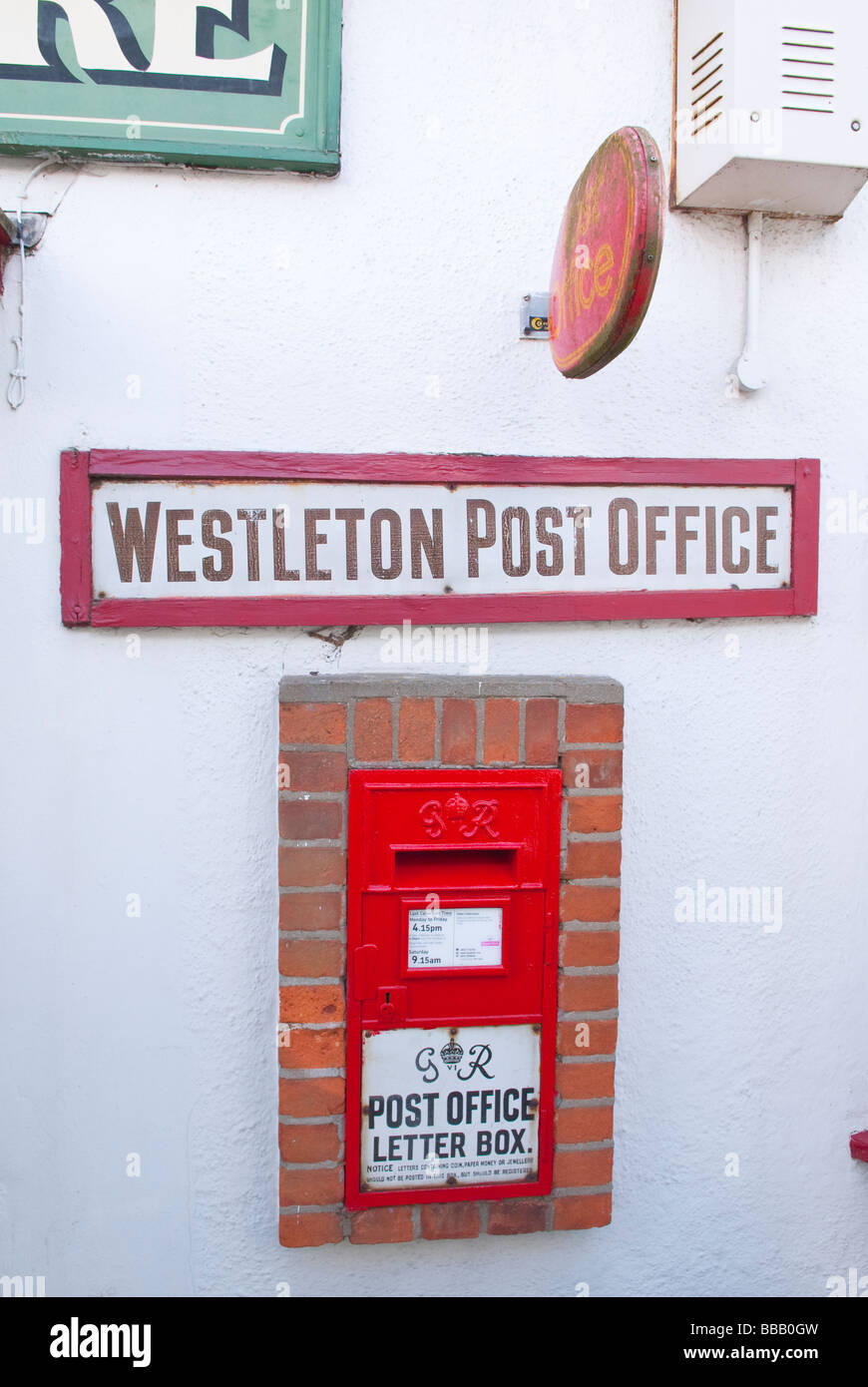 The Royal Mail letter post box outside Lincoln's village store,the local shop and post office in Westleton,Suffolk,Uk Stock Photo
