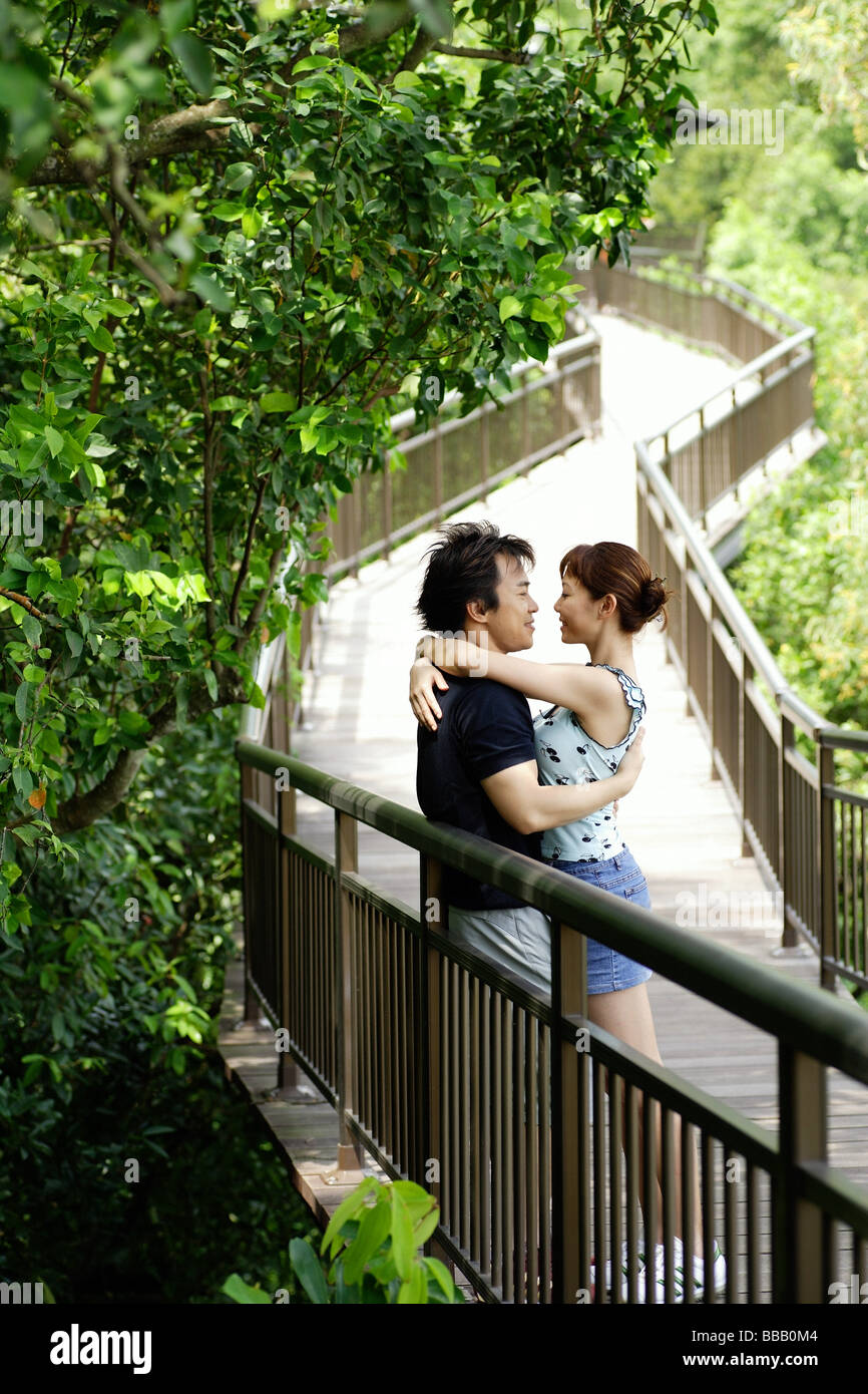 Couple hugging in park Stock Photo - Alamy
