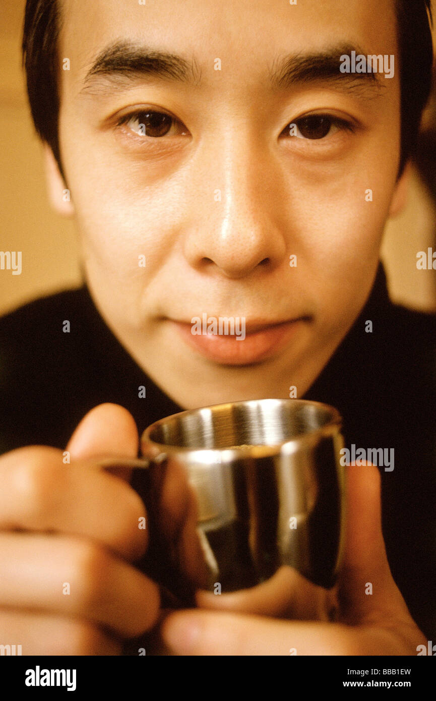 Man holding silver cup, portrait. Stock Photo