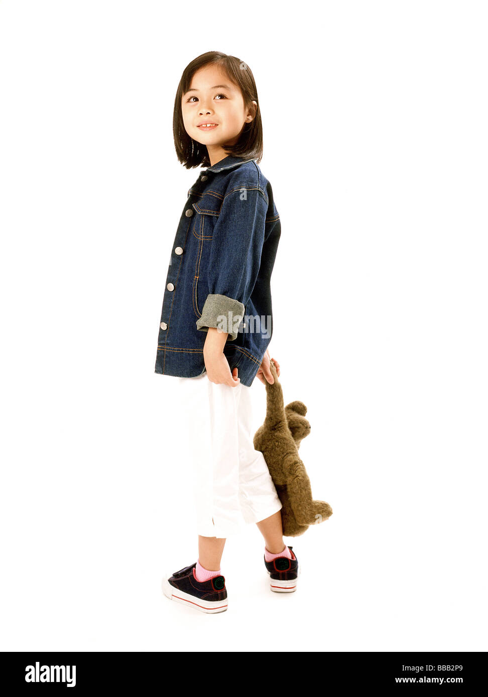 Young girl holding teddy bear, white background Stock Photo - Alamy