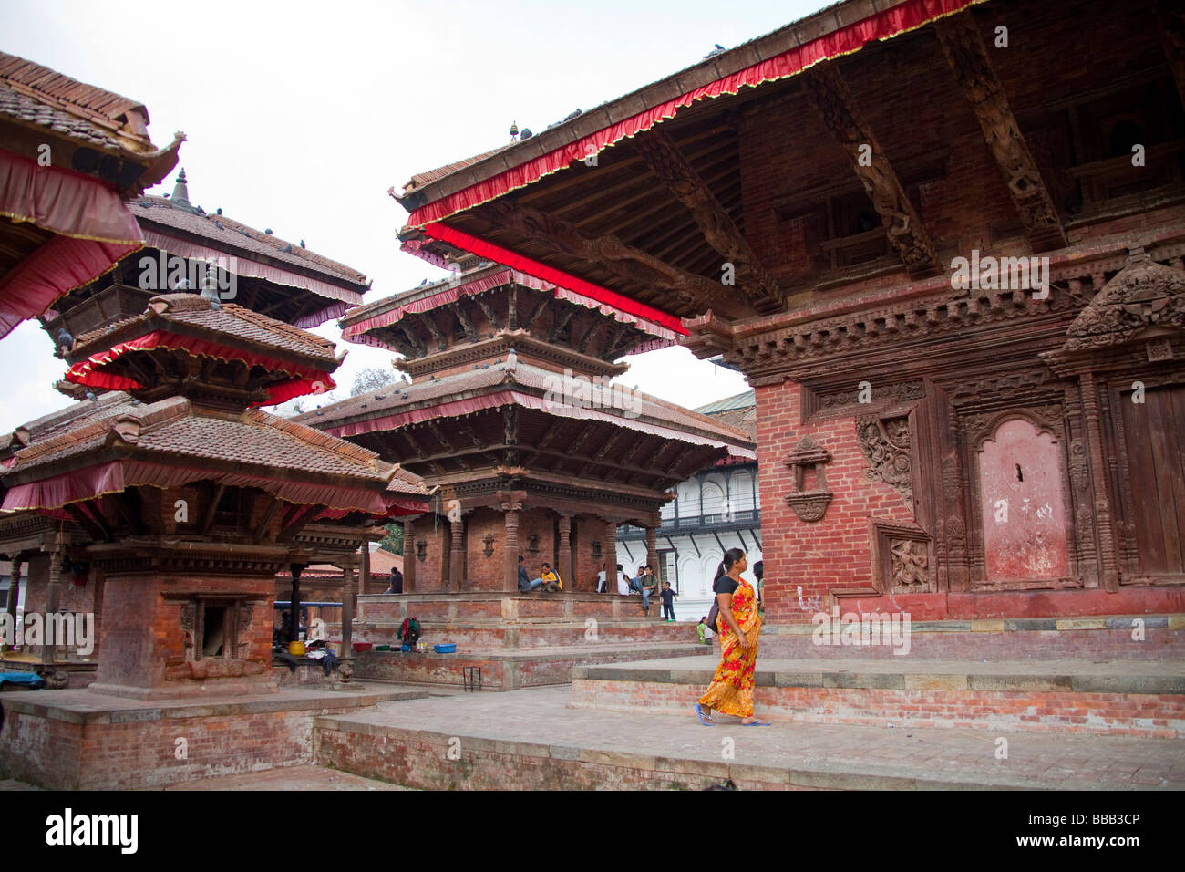 Old Hindu temple and nepalese woman passing by, Kathmandu Nepal 93590 ...