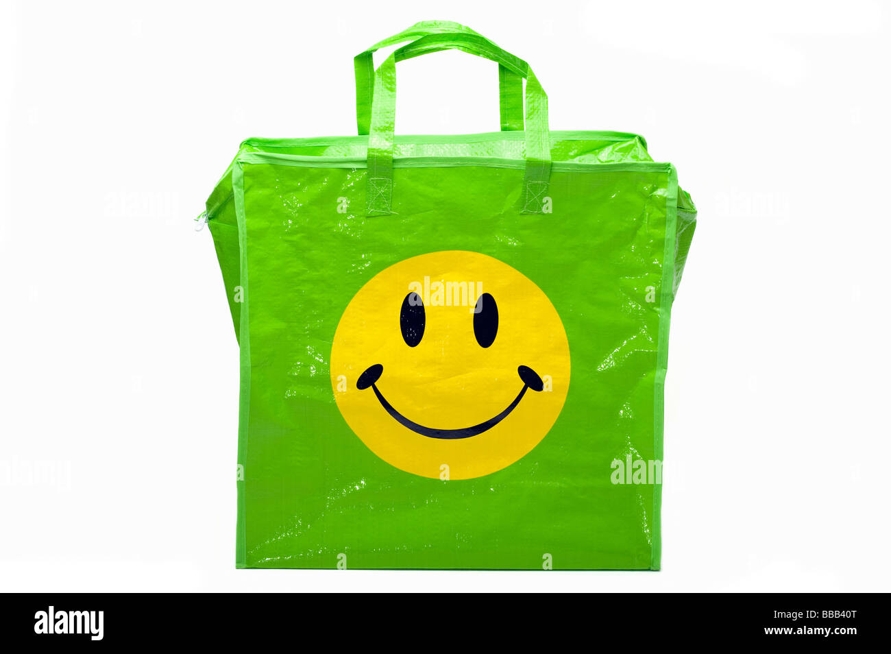 Green and yellow smiley face on a plastic carrier bag Stock Photo