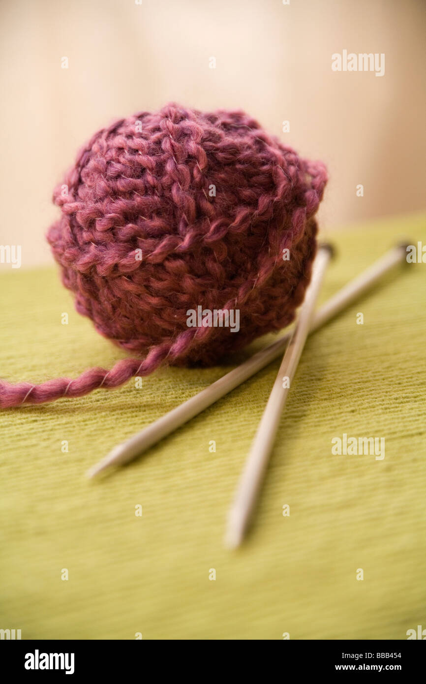 Ball of yarn and two knitting needles Stock Photo Alamy