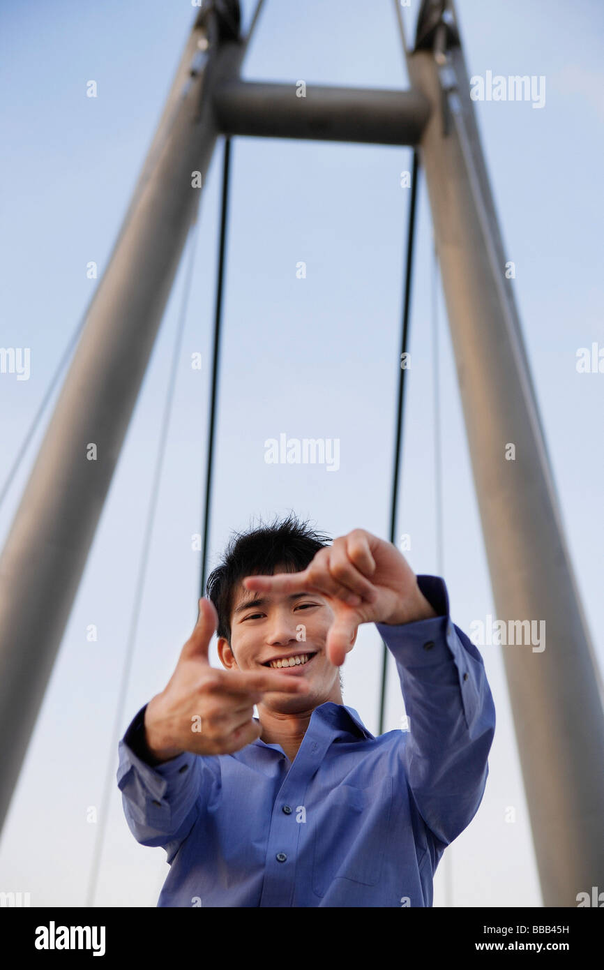 young man framing picture with fingers Stock Photo