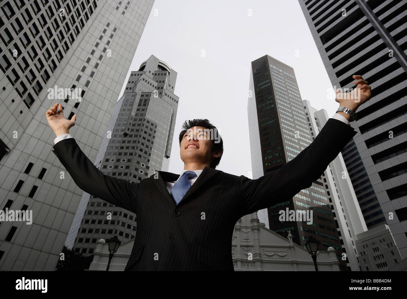 Businessman raising arms in air Stock Photo - Alamy