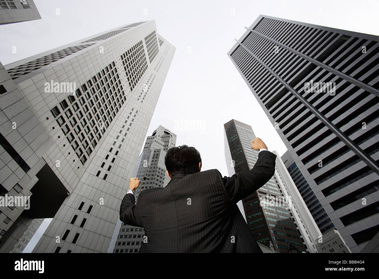 Businessman raising arms in air Stock Photo - Alamy