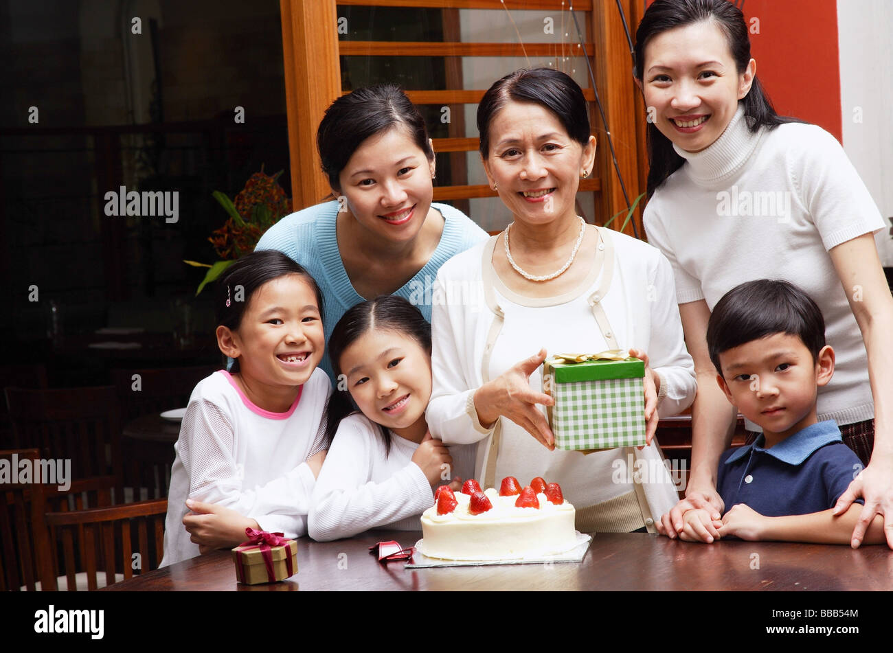 Family celebrating birthday, looking at camera Stock Photo