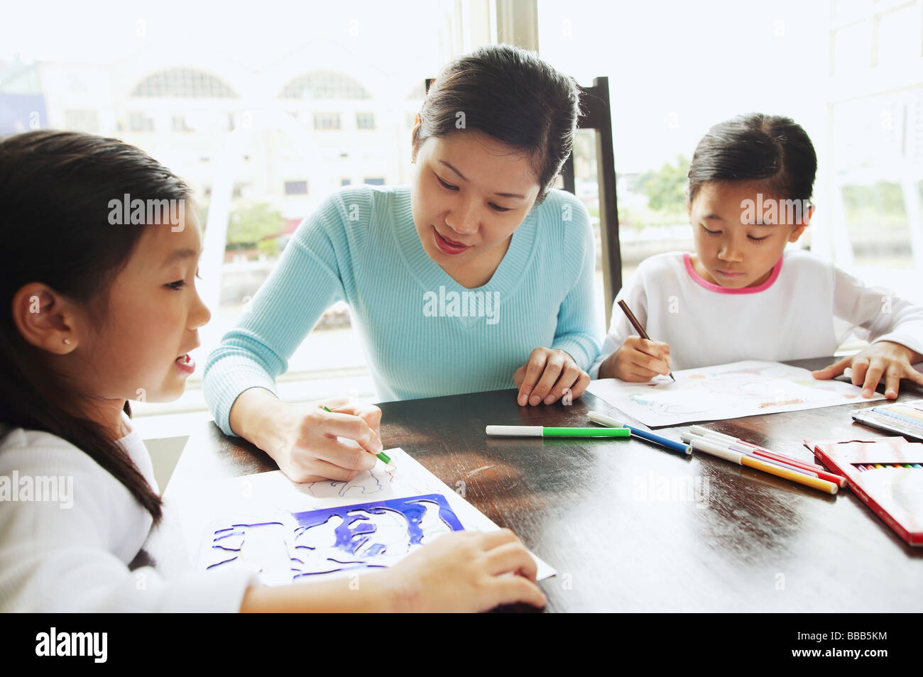 Mother with two girls, drawing Stock Photo